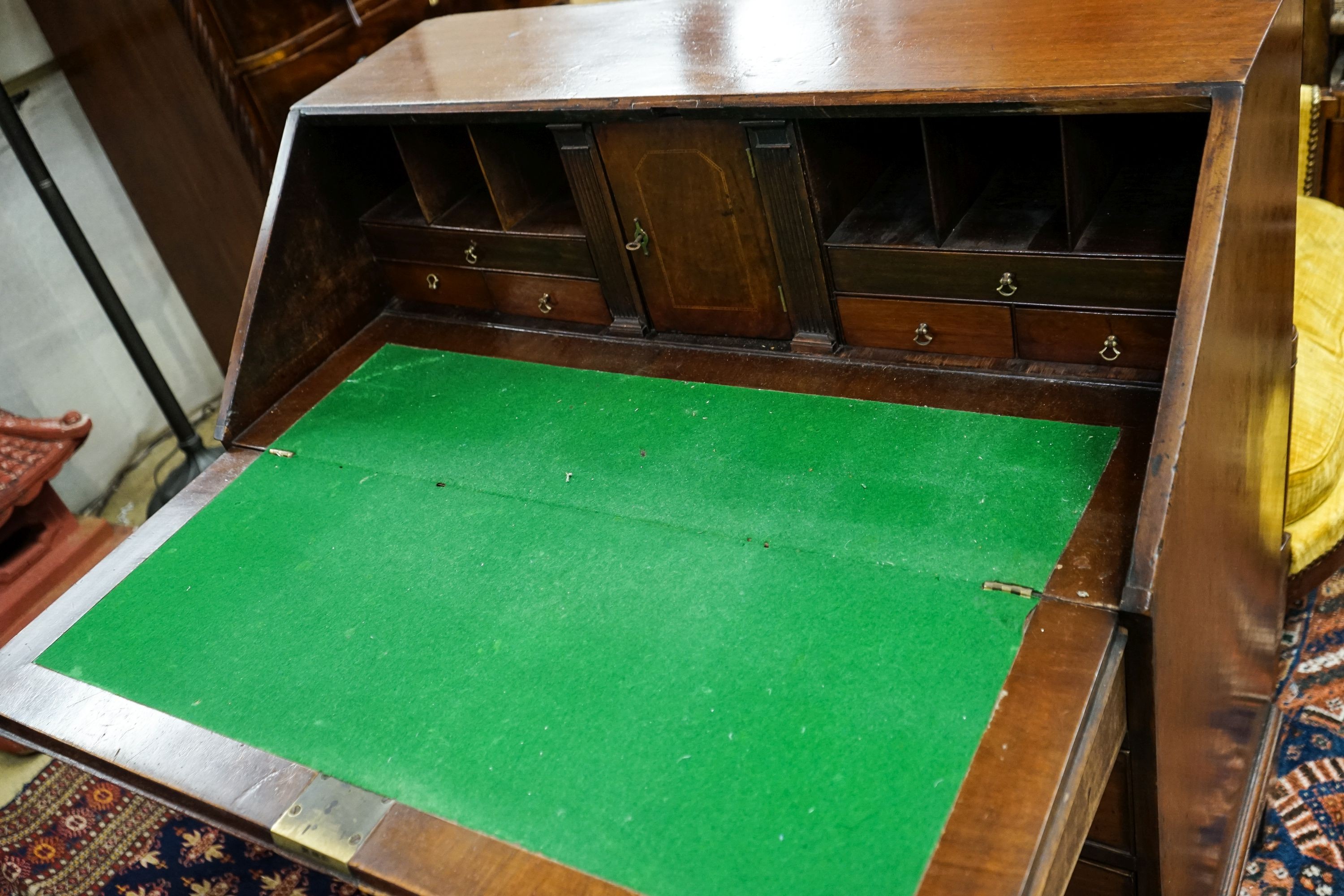 A George III mahogany bureau, with fall front and four drawers, width 91cm, depth 50cm, height 102cm